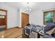 Bedroom featuring decorative light fixture, wood framed windows and wood closet doors at 9722 N Gasburg Rd, Mooresville, IN 46158