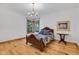 Charming bedroom with a detailed wooden bed frame, quilt and beautiful wood floors at 9722 N Gasburg Rd, Mooresville, IN 46158