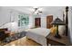 Well-lit bedroom features a large window with outdoor views, hardwood floors, and a ceiling fan at 9722 N Gasburg Rd, Mooresville, IN 46158