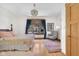 A bedroom with a bed, side table, hardwood floors, light colored walls, and a large window with natural light at 9722 N Gasburg Rd, Mooresville, IN 46158