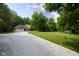 Exterior view of the home featuring a long driveway leading to a well-maintained lawn and landscaped surroundings at 9722 N Gasburg Rd, Mooresville, IN 46158