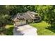 Inviting yellow two-story home boasts an attached two-car garage and a charming covered front porch with stone supports at 9722 N Gasburg Rd, Mooresville, IN 46158