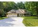 Inviting yellow two-story home boasts an attached two-car garage and a charming covered front porch with stone supports at 9722 N Gasburg Rd, Mooresville, IN 46158