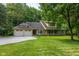 Charming exterior of home with a well-manicured lawn, a gravel driveway, and a welcoming front porch at 9722 N Gasburg Rd, Mooresville, IN 46158