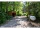 Exterior of property featuring a convenient wood shed and a propane tank, surrounded by lush greenery and trees at 9722 N Gasburg Rd, Mooresville, IN 46158