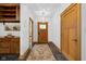 Hallway featuring built-in wood cabinets and drawers with decorative rug and front door at 9722 N Gasburg Rd, Mooresville, IN 46158