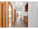 Inviting hallway with wood trim, tiled floor, and built-in cabinets leads to rooms with bright interiors at 9722 N Gasburg Rd, Mooresville, IN 46158