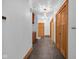 Hallway with slate floors, wood doors and trim, and decorative light fixtures at 9722 N Gasburg Rd, Mooresville, IN 46158