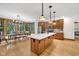 A kitchen features wooden cabinets, stainless steel appliances, and an island with a white countertop at 9722 N Gasburg Rd, Mooresville, IN 46158