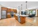 An open concept kitchen with stainless appliances, a center island, and hardwood floors leading to the living room at 9722 N Gasburg Rd, Mooresville, IN 46158