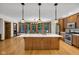 The bright kitchen features a large central island, pendant lighting, and stainless steel appliances, perfect for entertaining at 9722 N Gasburg Rd, Mooresville, IN 46158