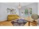 Bright living room with large windows, chandelier, hardwood floors, and a yellow sofa at 9722 N Gasburg Rd, Mooresville, IN 46158