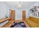 Bright room showcases a stylish yellow couch, area rug, desk and decor, illuminated by a modern chandelier at 9722 N Gasburg Rd, Mooresville, IN 46158