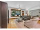 Sunlit living room with hardwood floors, a comfortable sofa, and a decorative light fixture creates a cozy gathering space at 9722 N Gasburg Rd, Mooresville, IN 46158