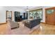 Inviting living room showcases hardwood floors, neutral decor, and natural light streaming through the beautiful front windows at 9722 N Gasburg Rd, Mooresville, IN 46158