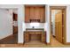 A home office space features wood floors, cabinets, drawers, granite countertop, and open doorway to a closet at 9722 N Gasburg Rd, Mooresville, IN 46158