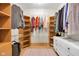 A well-organized walk-in closet provides ample shelving and hanging space for clothes and accessories at 9722 N Gasburg Rd, Mooresville, IN 46158