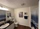 A bathroom featuring a dark vanity, updated lighting, and a shower with a curtain at 1001 Paradise Ct # F, Greenwood, IN 46143