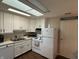Kitchen with white cabinets, appliances, and a skylight at 1001 Paradise Ct # F, Greenwood, IN 46143