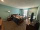 A cozy bedroom with a unique accent wall, a comfortable bed, and natural lighting at 1001 Paradise Ct # F, Greenwood, IN 46143