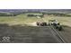 Farmland aerial view featuring fields, a farm house, and trees at 10769 Shelbyville Rd, Indianapolis, IN 46259