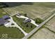 Expansive aerial view of a country estate, featuring well-manicured lawns, multiple buildings and surrounding fields at 10769 Shelbyville Rd, Indianapolis, IN 46259