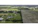 Expansive aerial shot showcasing properties, farmland, and lush greenery at 10769 Shelbyville Rd, Indianapolis, IN 46259