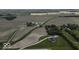 Aerial view showcasing properties surrounded by farmland and mature trees at 10769 Shelbyville Rd, Indianapolis, IN 46259