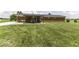 Spacious backyard featuring a covered patio with a table and chairs, perfect for enjoying outdoor meals at 10769 Shelbyville Rd, Indianapolis, IN 46259