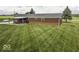 Aerial view of home with brick exterior, pergola covered patio, and expansive green backyard at 10769 Shelbyville Rd, Indianapolis, IN 46259