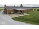 Brick home exterior featuring a backyard brick patio with dining set and swing under a wood pergola at 10769 Shelbyville Rd, Indianapolis, IN 46259