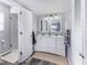 Bright bathroom with double sink vanity, two mirrors, and walk-in shower at 10769 Shelbyville Rd, Indianapolis, IN 46259