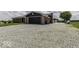 Spacious gravel driveway leading to a two-car garage, offering ample parking at 10769 Shelbyville Rd, Indianapolis, IN 46259