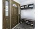 Inviting entryway features a shoe rack, a coat rack, and a decorative wood door with sidelights at 10769 Shelbyville Rd, Indianapolis, IN 46259