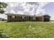 Well-maintained brick home with a two-car garage and expansive front lawn at 10769 Shelbyville Rd, Indianapolis, IN 46259