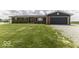 Charming brick home with a well-manicured lawn and an attached garage, perfect for comfortable living at 10769 Shelbyville Rd, Indianapolis, IN 46259