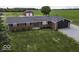 Aerial view of a brick home with a well-maintained lawn and attached garage at 10769 Shelbyville Rd, Indianapolis, IN 46259