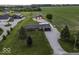 A home with an outbuilding sits on a manicured lawn with gravel driveway at 10769 Shelbyville Rd, Indianapolis, IN 46259