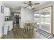 Eat-in kitchen area with wood flooring, a ceiling fan, and a sliding glass door to the backyard at 10769 Shelbyville Rd, Indianapolis, IN 46259