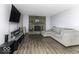 Bright living room featuring a stone fireplace, large sofa and modern media center at 10769 Shelbyville Rd, Indianapolis, IN 46259