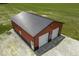 Aerial of red outbuilding with grey roof, white garage doors, and plenty of space for projects at 10769 Shelbyville Rd, Indianapolis, IN 46259