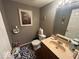 Bathroom with hardwood floors, toilet, single sink, and decoratively painted walls at 10780 Affirmed Dr, Indianapolis, IN 46234