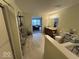 Upstairs full bathroom with dual sinks, commode, tile flooring, and tub at 10780 Affirmed Dr, Indianapolis, IN 46234