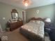 Carpeted bedroom with queen bed, dresser, window and ceiling fan at 10780 Affirmed Dr, Indianapolis, IN 46234