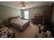 Carpeted bedroom with queen size bed, dresser, window and ceiling fan at 10780 Affirmed Dr, Indianapolis, IN 46234