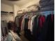 Walk-in closet with clothes hanging on racks and other items stored on shelves above at 10780 Affirmed Dr, Indianapolis, IN 46234