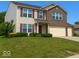 Charming two-story home with a well-manicured lawn and beautiful landscaping at 10780 Affirmed Dr, Indianapolis, IN 46234