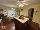 Bright eat-in kitchen with wood cabinets, tile flooring, central island and modern white appliances at 10780 Affirmed Dr, Indianapolis, IN 46234