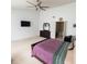Large main bedroom with large ceiling fan, dresser, TV, and ensuite bathroom at 10780 Affirmed Dr, Indianapolis, IN 46234