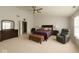 Large main bedroom with ceiling fan, dresser, occasional chair, and ensuite bathroom at 10780 Affirmed Dr, Indianapolis, IN 46234